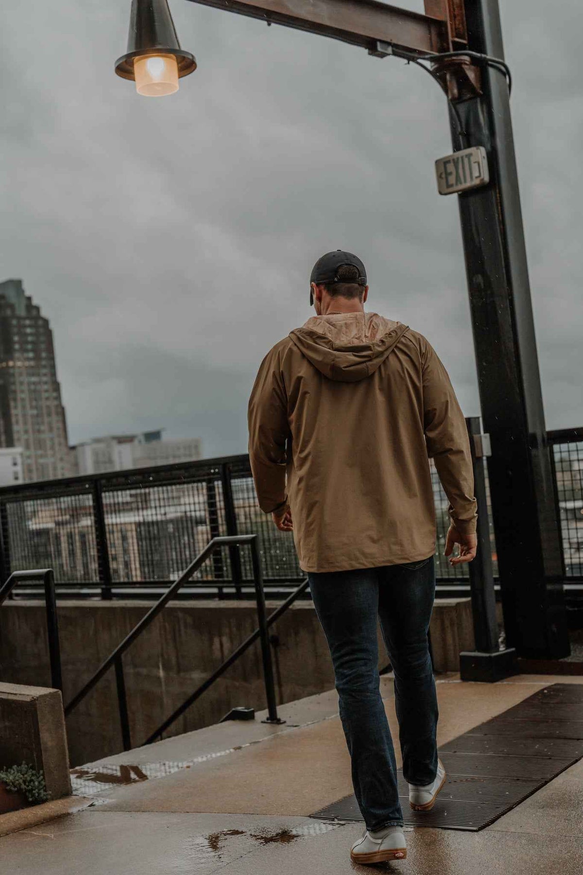 Men's olive Journey jacket from back with hood and zip-up silhouette
