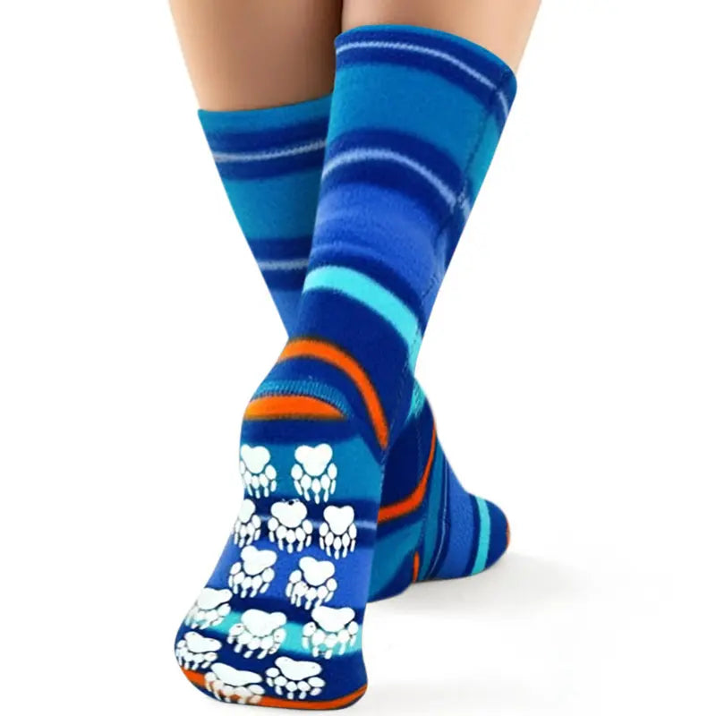 Kids’ striped fleece socks worn; blue and turquoise bands with orange curves and pawprint grippers