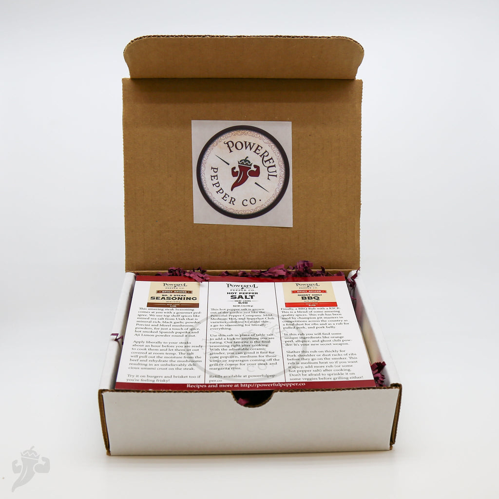 BBQ spice gift pack open with three labeled seasoning bottles and printed insert