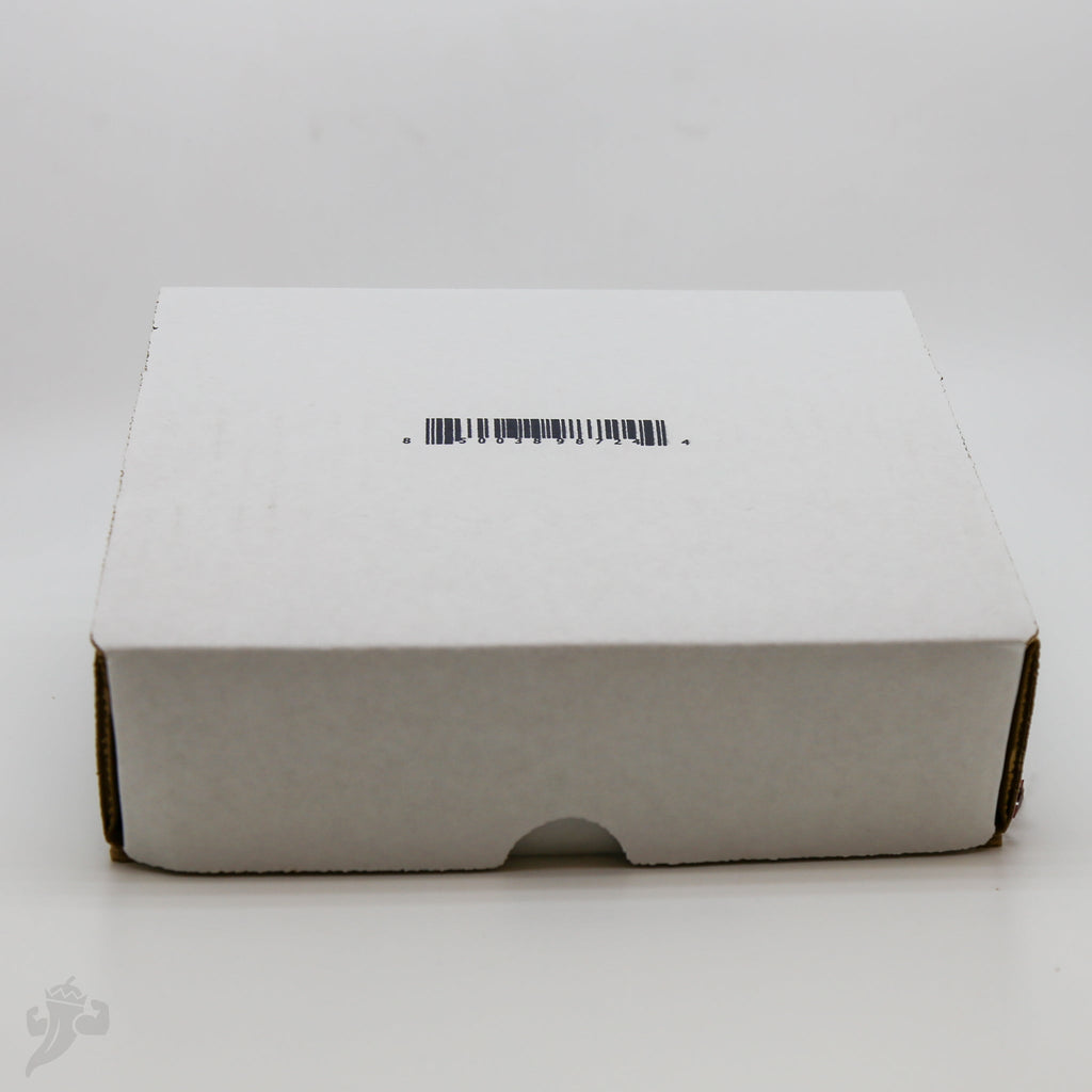 Closed white BBQ spice gift pack box with barcode sticker on top panel