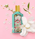 Gucci Flora Gorgeous Jasmine eau de parfum bottle with gold cap and white orchids