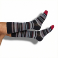 Pair of black dress socks with red toe, heel, and multicolor stripe bands