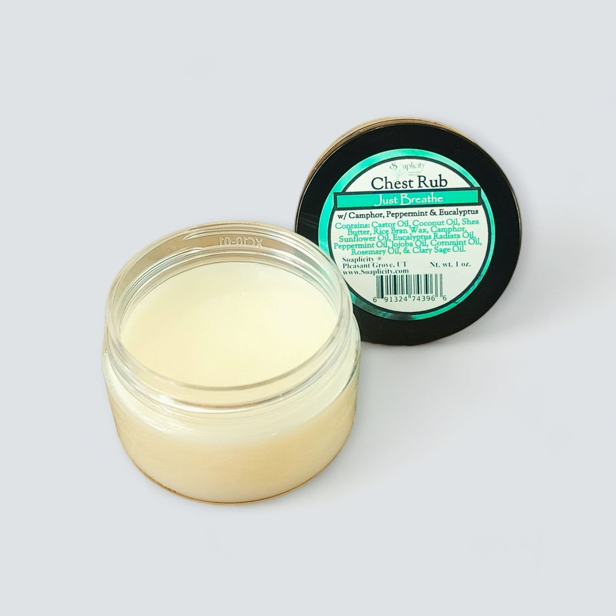 Chest rub balm in open clear jar beside black-lidded container
