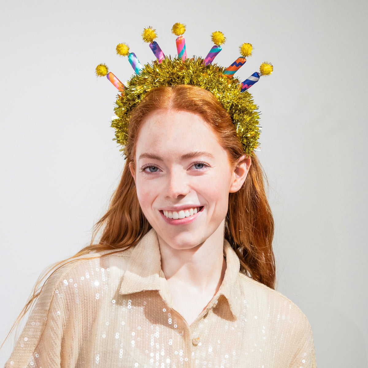 Birthday candle novelty headband: gold tinsel band with colorful printed candle sleeves