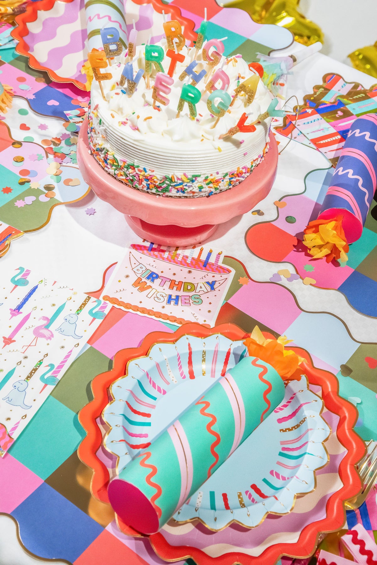 Birthday crackers on a party table with colorful confetti and cake decorations