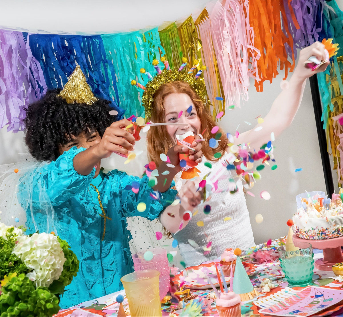 Birthday party cracker set with confetti and candle toppers, crackers held at birthday table