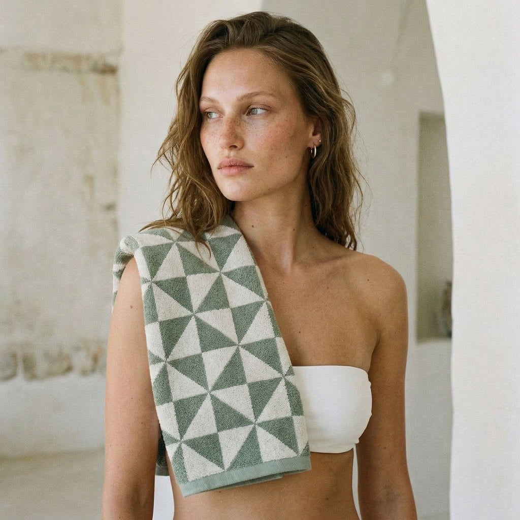 Australian cotton towels, green geometric triangle pattern towel draped over the shoulder