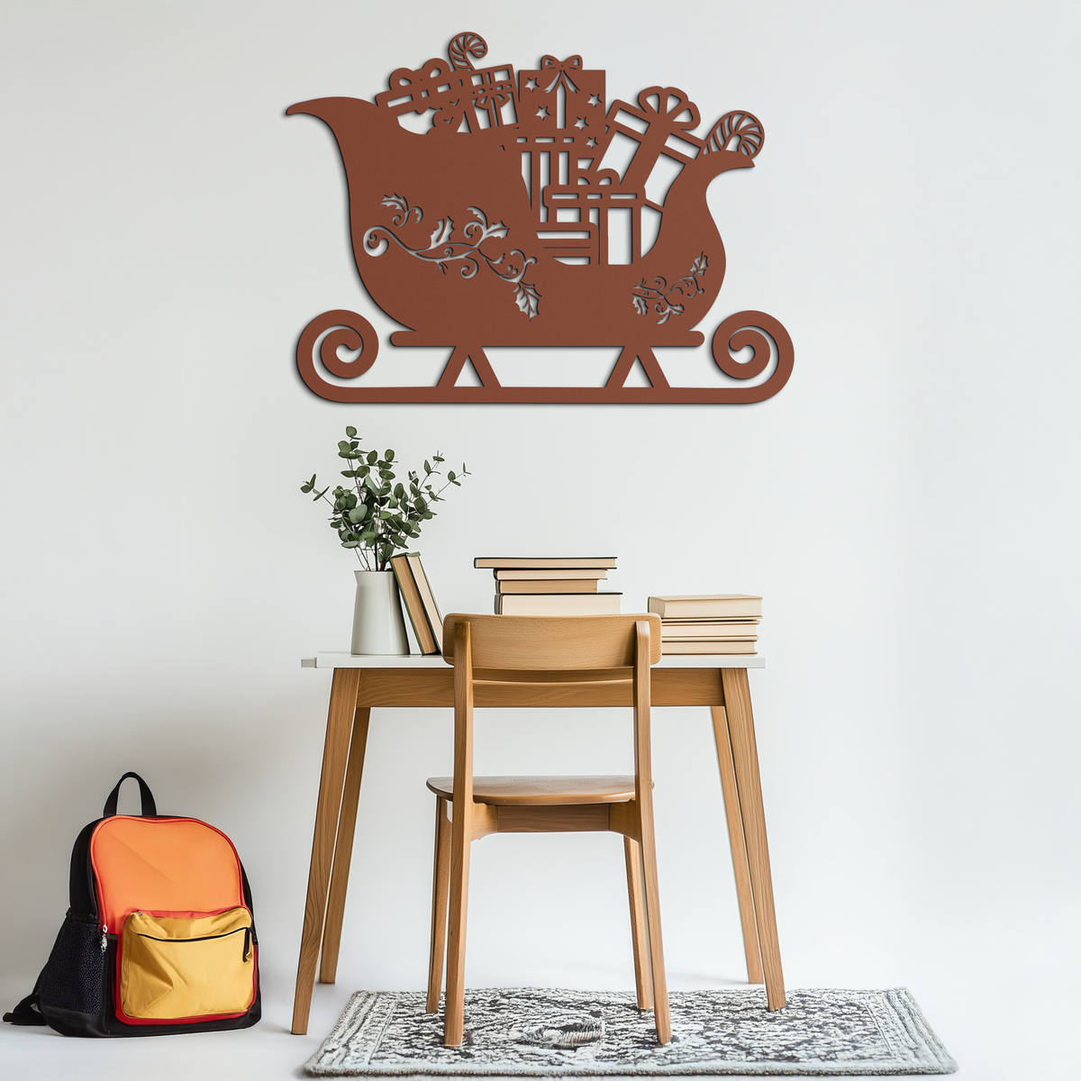 Sleigh-shaped metal wall art with gift and tree cutouts, bronze finish