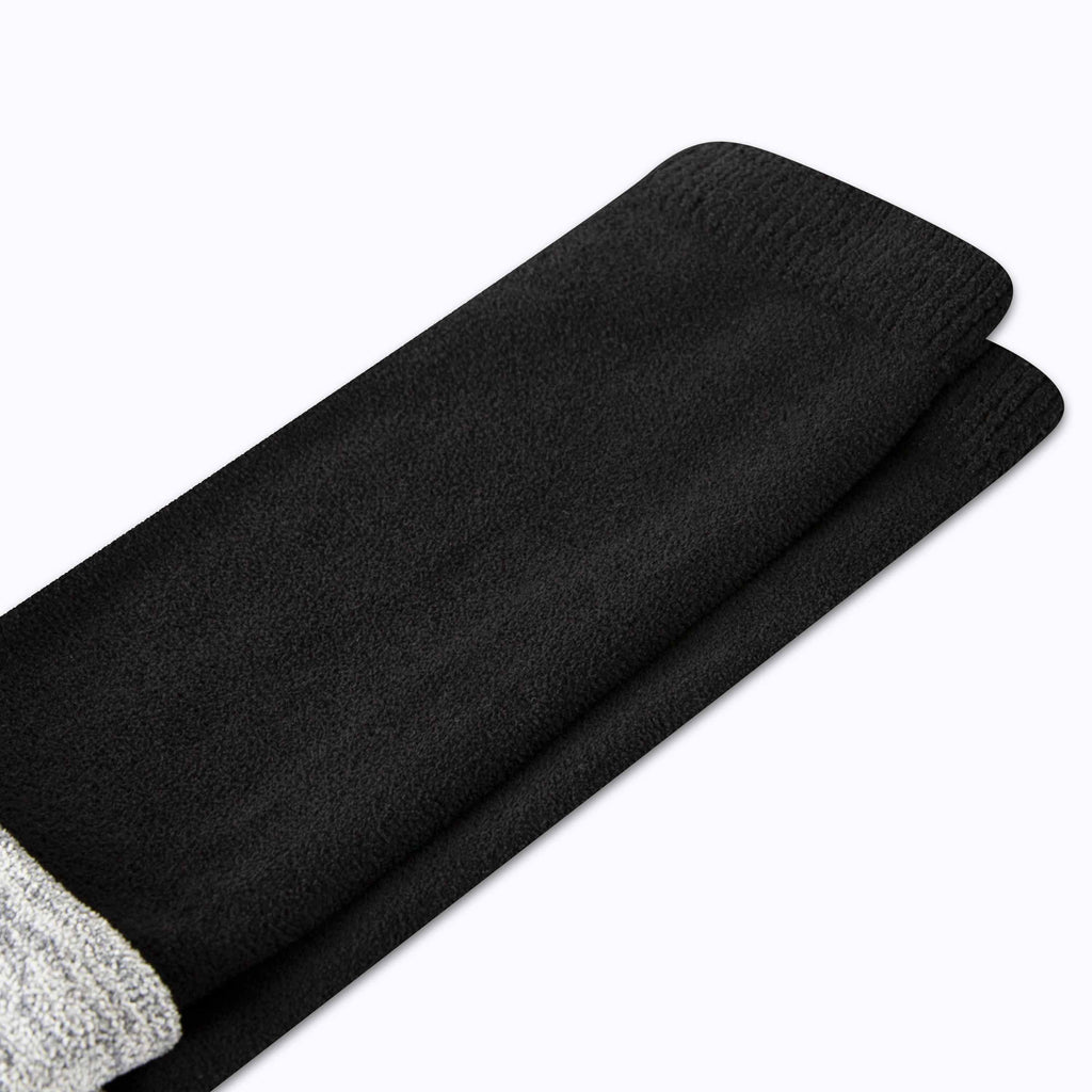 CozyGrip compression slipper sock fabric close-up: solid black knit leg