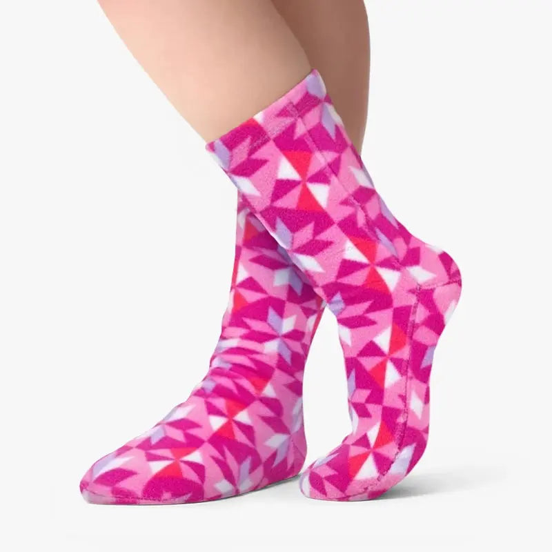 Fleece crew socks in pink and white geometric triangle pattern on a leg