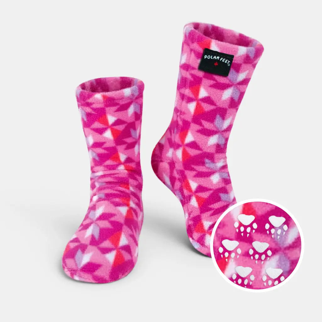 Pink and white fleece crew socks with geometric pattern and paw-print grip sole