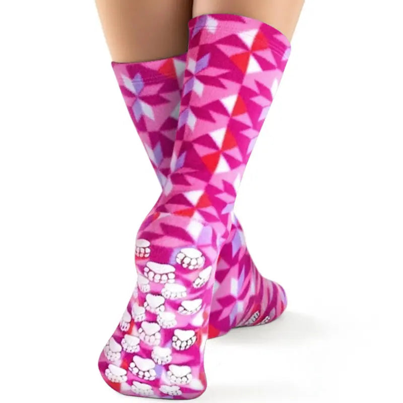 Kids fleece nonskid socks in pink geometric pattern with white paw-print grip
