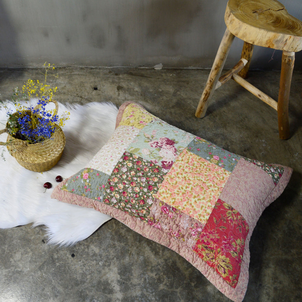 Patchwork floral cotton pillow sham with quilted border and multicolor patchwork front