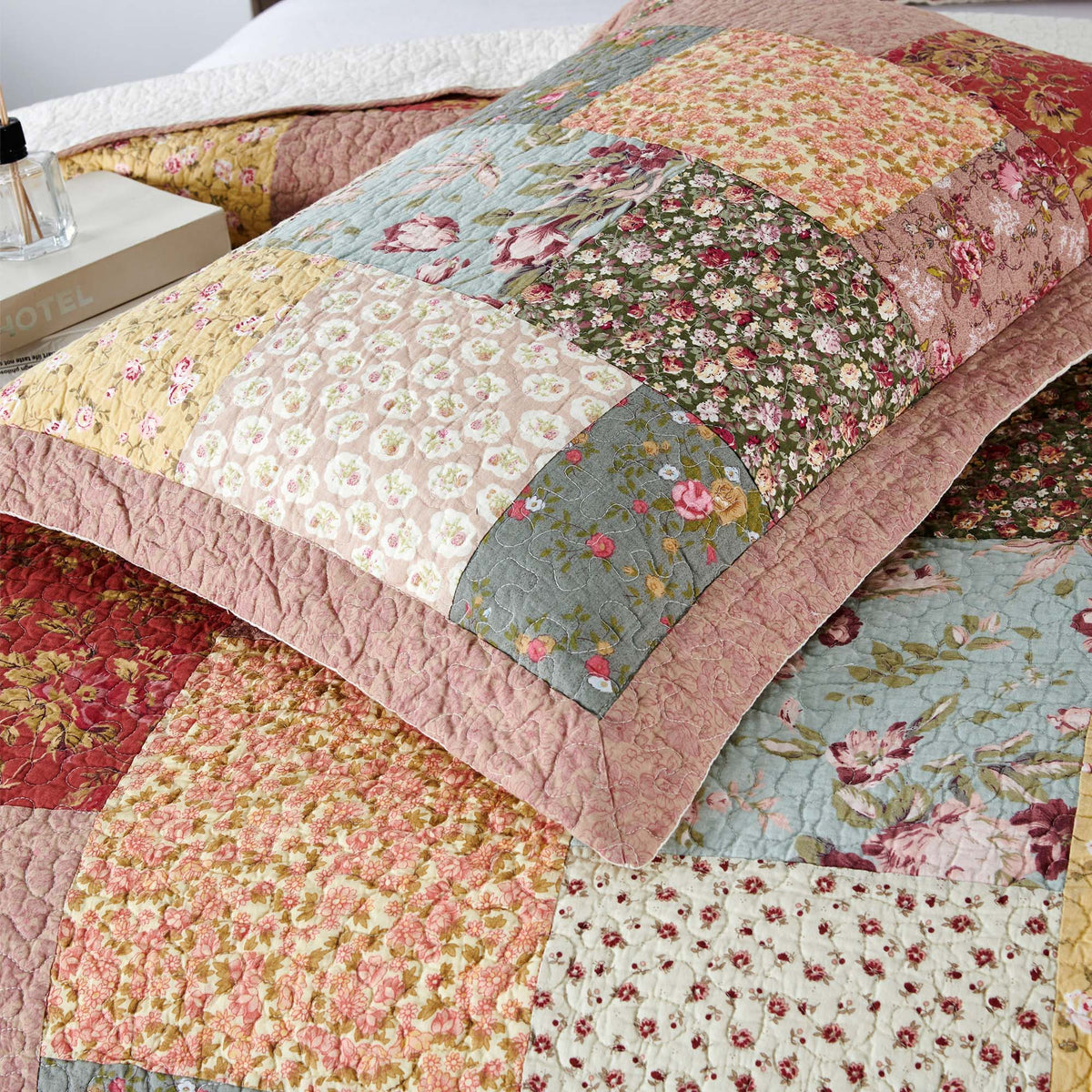Quilted patchwork floral pillow shams with ruffled borders, multicolor fabric blocks