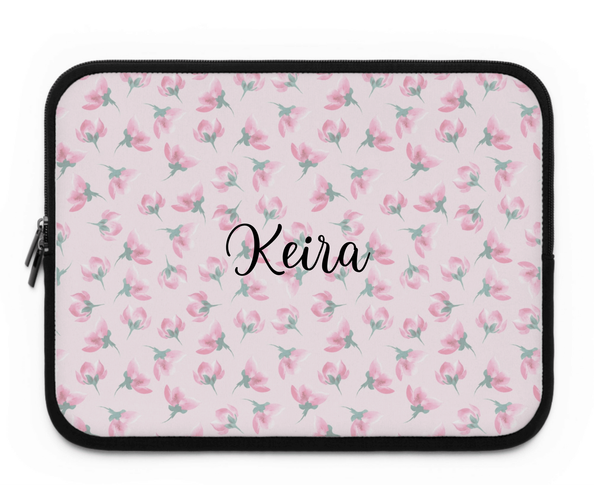 Floral laptop sleeve with 'Keira' name text, pink-green flowers, black zipper edge