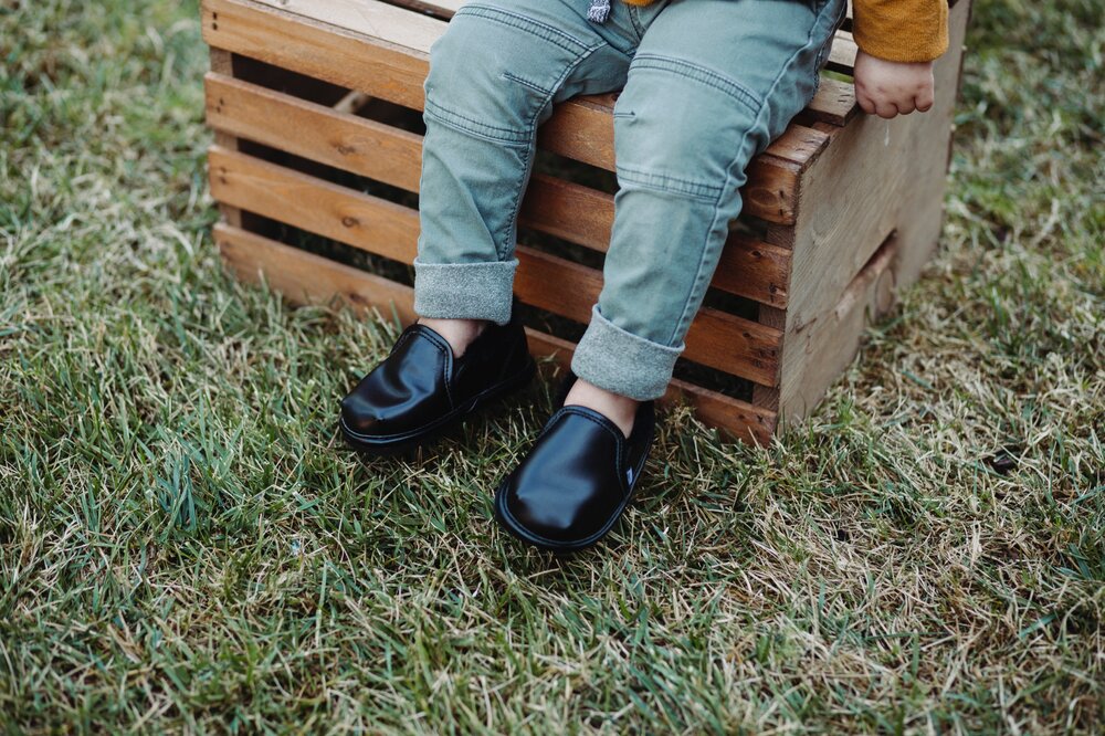 Kids’ black slip-on boots with cushioned uppers and dark soles