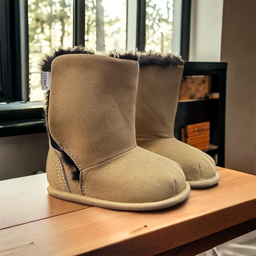 Kids’ tan suede slip-on boots with fuzzy cuff on display