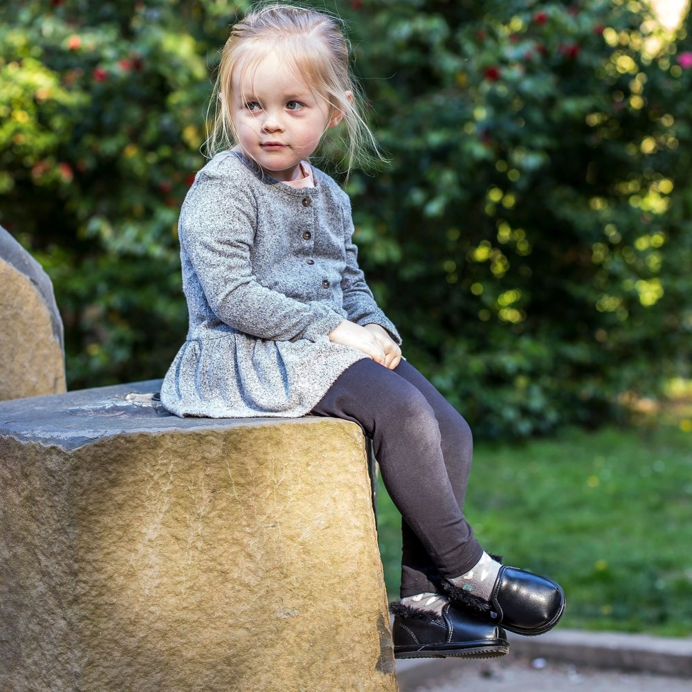 Kids’ black slip-on boots with thick soles outdoors