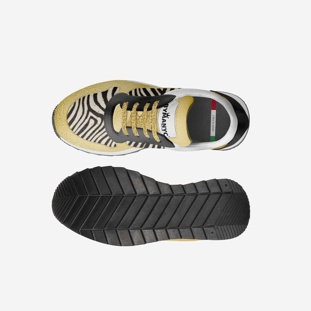 Kids' zebra-print vegan sneakers with gold laces and black rubber tread sole.