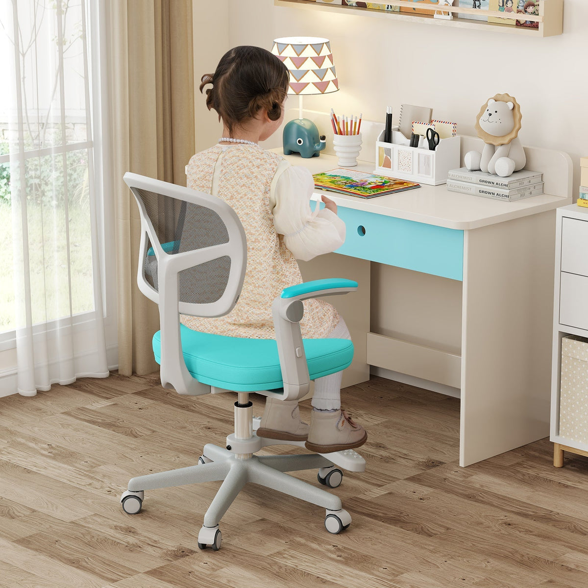 Kids desk chair with adjustable height, armrest, and footrest; turquoise fabric seat.
