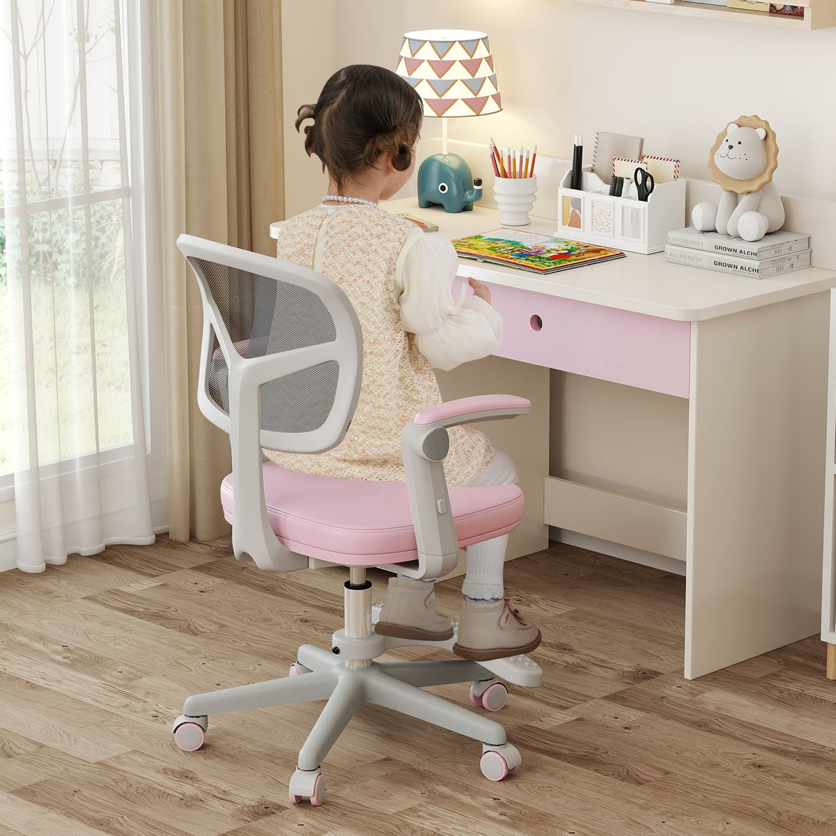 Kids desk chair with adjustable height, armrest, and footrest; pink fabric seat.