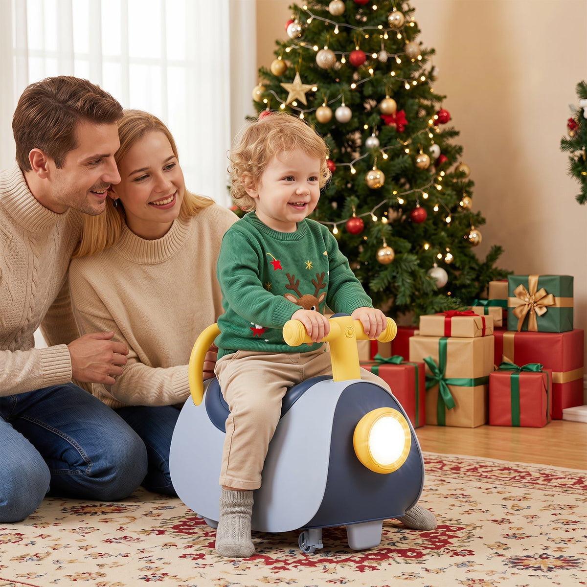Blue push ride-on car with glowing headlight, child riding with family nearby