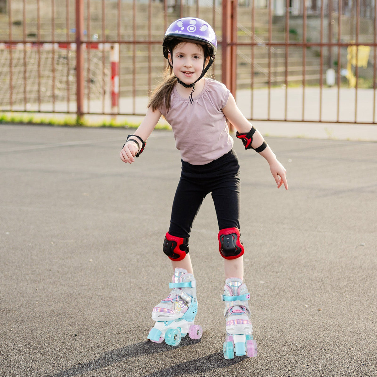 Kids adjustable quad roller skates in light blue and silver with glowing wheels
