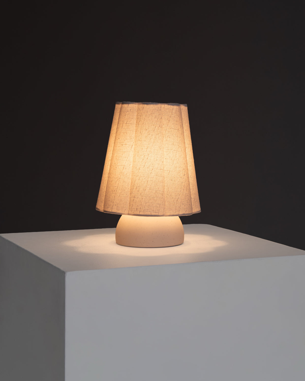 Kylie table lamp with amber-lit textured drum shade and white base