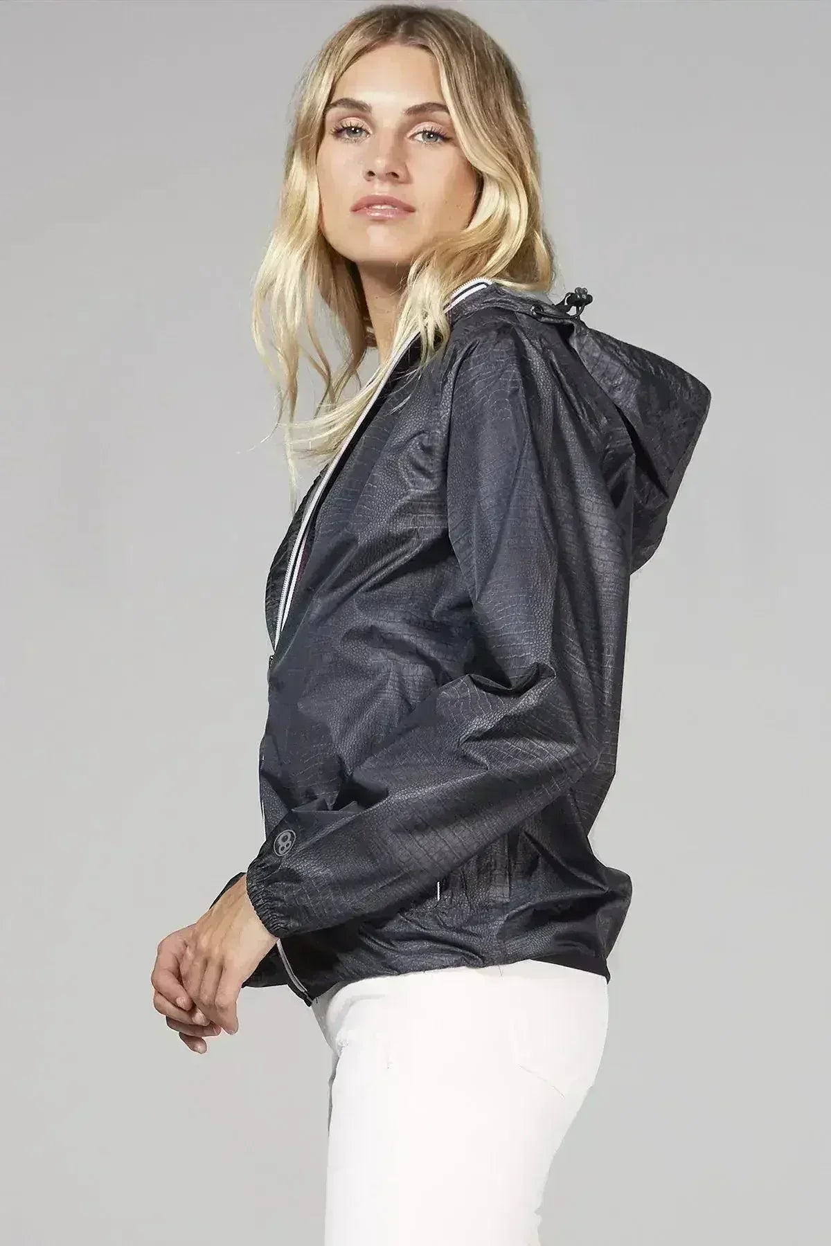 Women’s dark hooded windbreaker with full-zip front and elastic cuffs