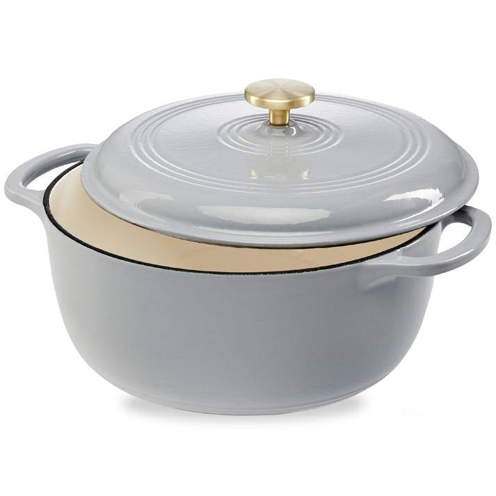 Light grey enamel cast-iron Dutch oven with lid, gold knob, and two side handles