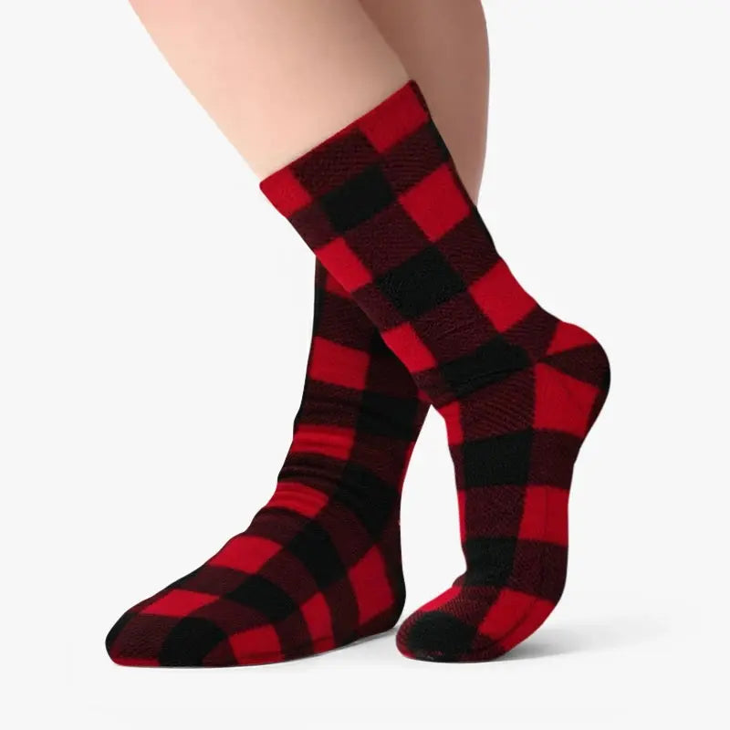Red and black buffalo plaid fleece crew socks on foot, with ribbed cuff and toe.
