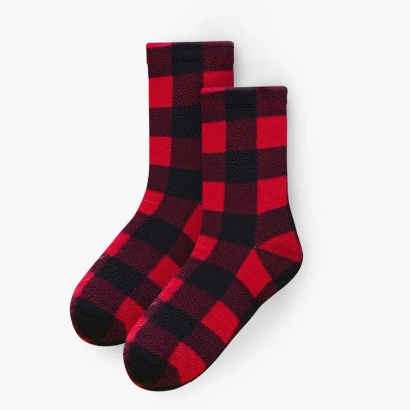 Pair of red and black buffalo plaid crew socks, fuzzy fleece texture and rounded toes.