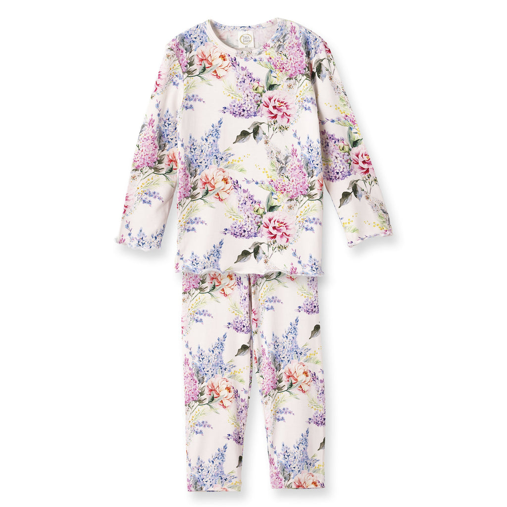 Kids pajama set with crewneck long sleeves and cuffed pants, white floral print.