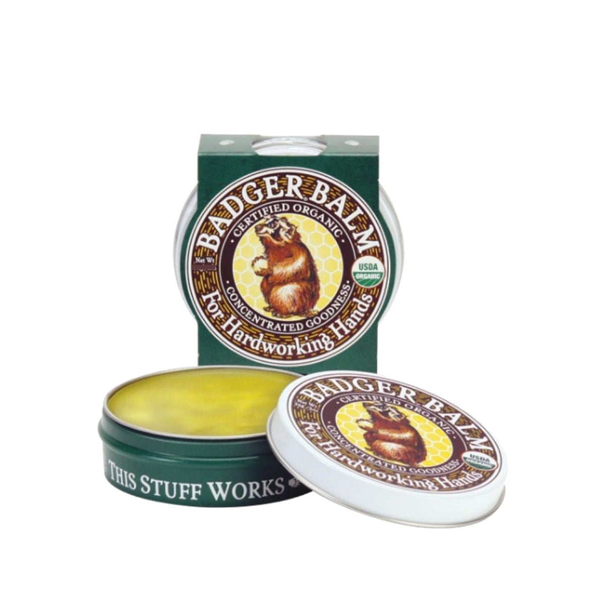 Badger Balm hand cream tin with green lid and open yellow balm