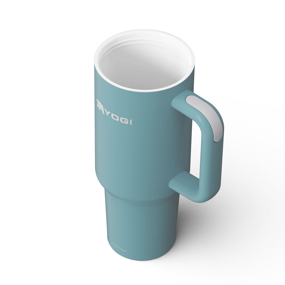 Ceramic-lined tumbler in blue with side handle and white interior rim.