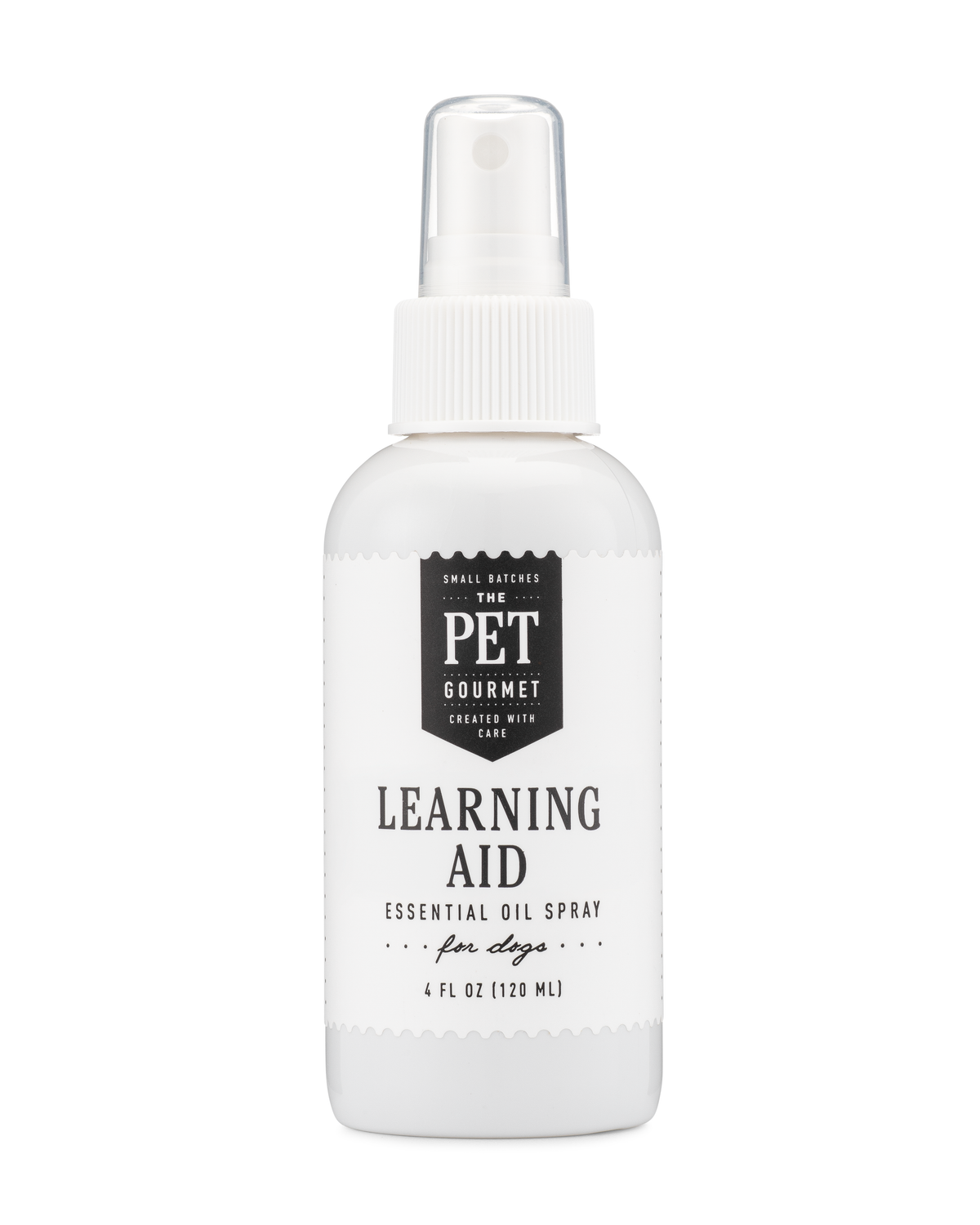 Essential oil spray for dogs bottle with pump, labeled “Learning Aid”.
