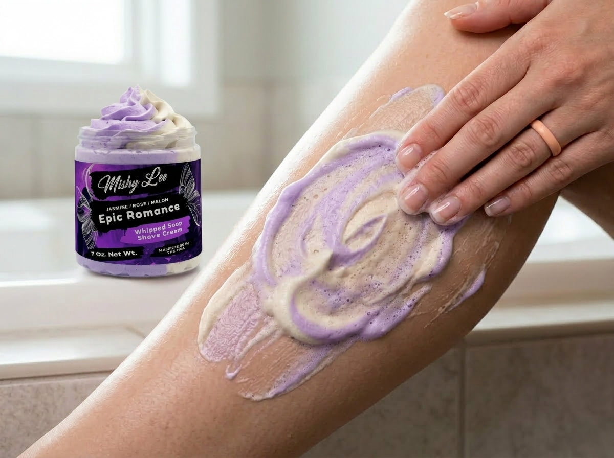 Hand applying purple and cream whipped shave soap to skin