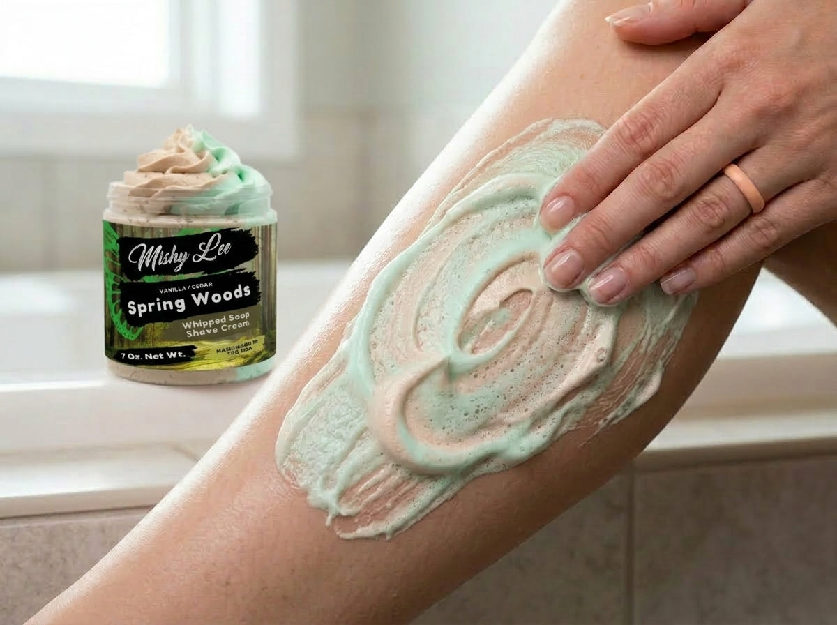 Mint and beige whipped soap and shave cream spread on forearm, jar in background