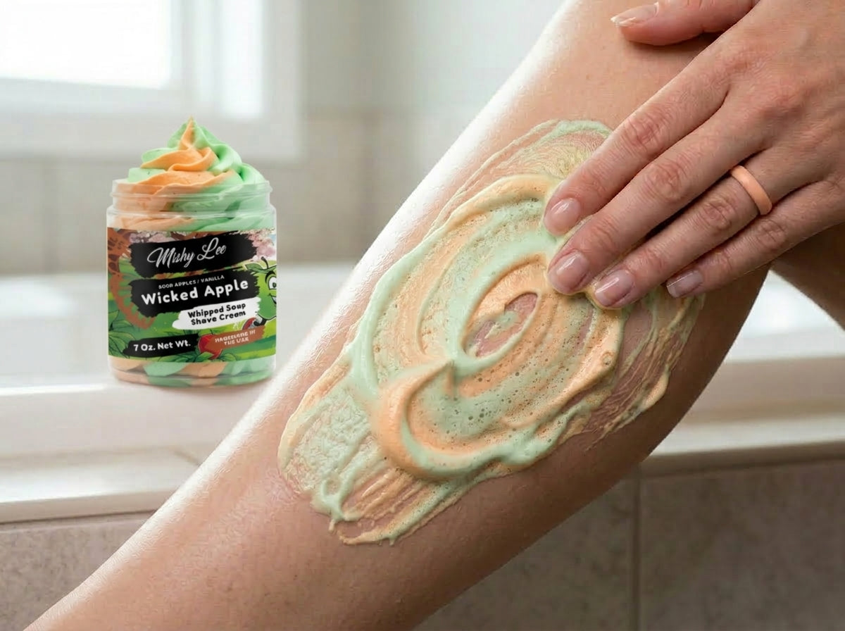 Whipped soap and shave cream spread on skin with green and orange swirl texture.