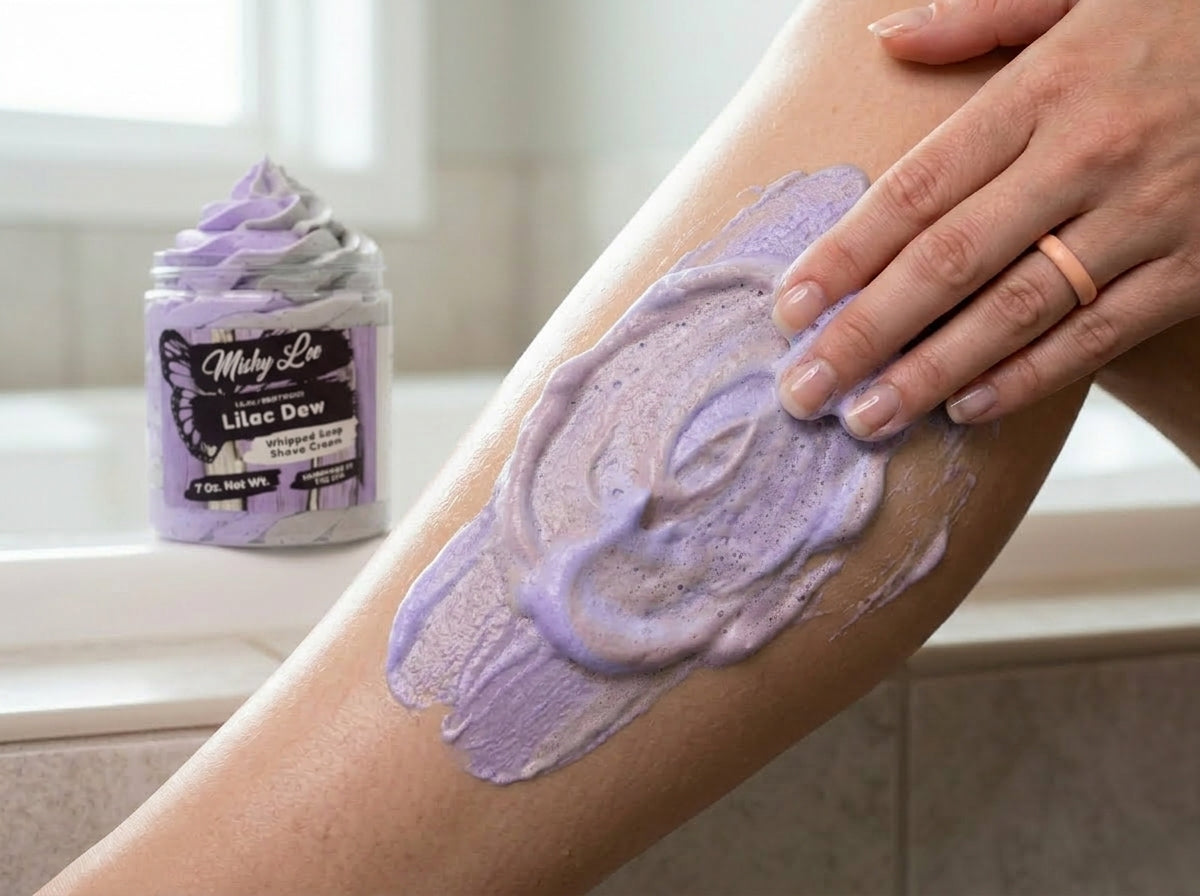Lilac whipped soap and shave cream spread on skin with jar in background