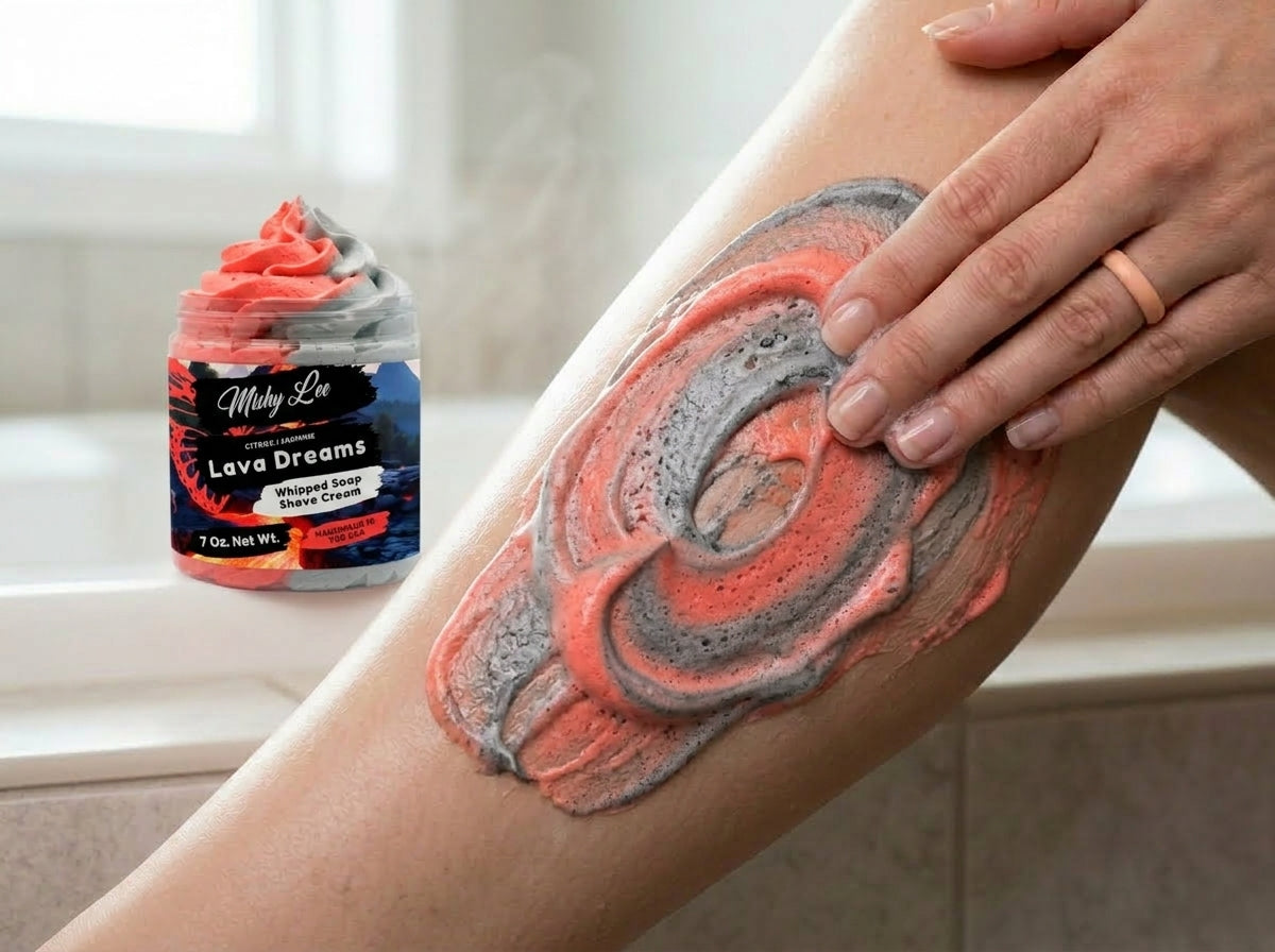 Red and gray cream swirled on skin with whipped soap and shave cream jar in view