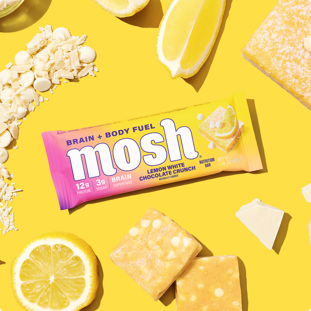 Mosh lemon white chocolate crunch energy bar with foil wrapper and bar pieces