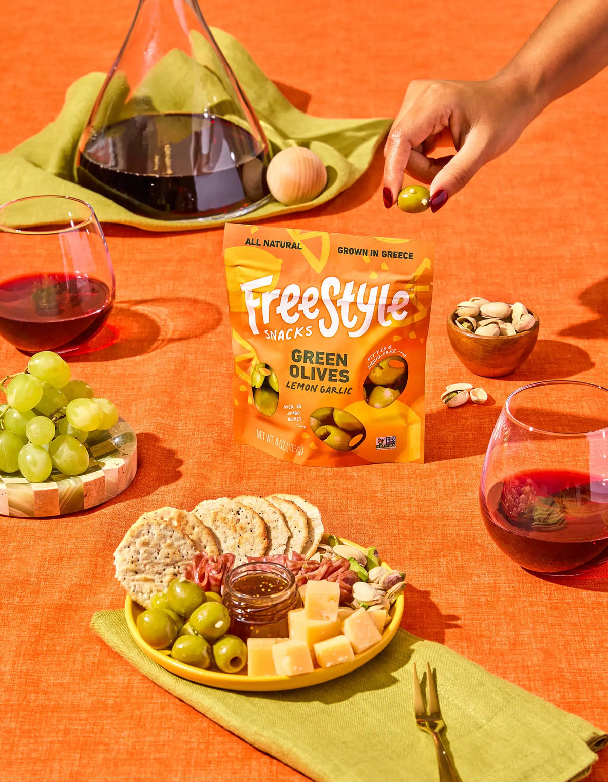 Green olive snack bag with lemon garlic olives and cheese on a platter