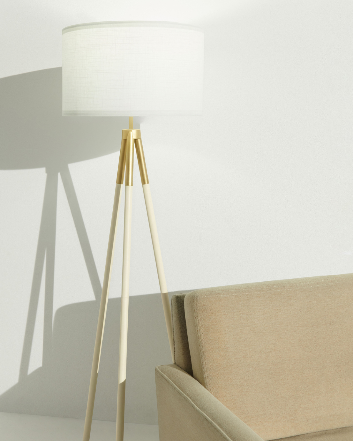 Levi floor lamp with white drum shade and light gold tripod legs