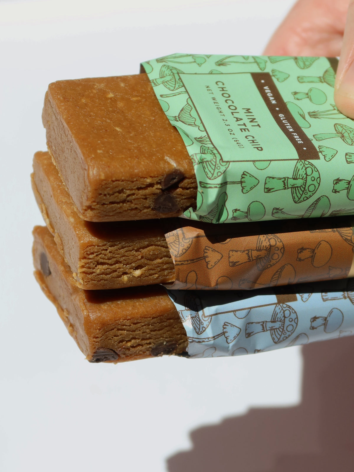 Protein snack bar stack with wrapped bars, variety pack colors, close-up