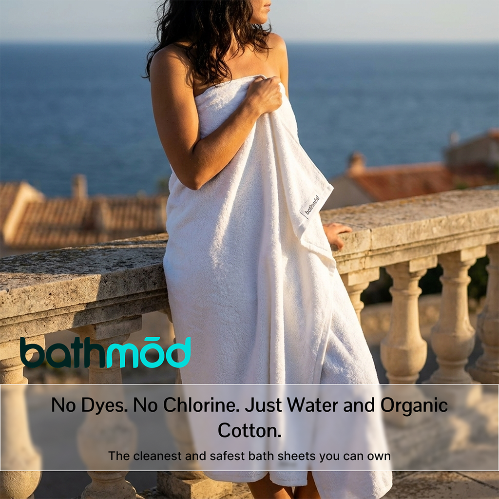 White bath sheet held by a person, terry texture visible