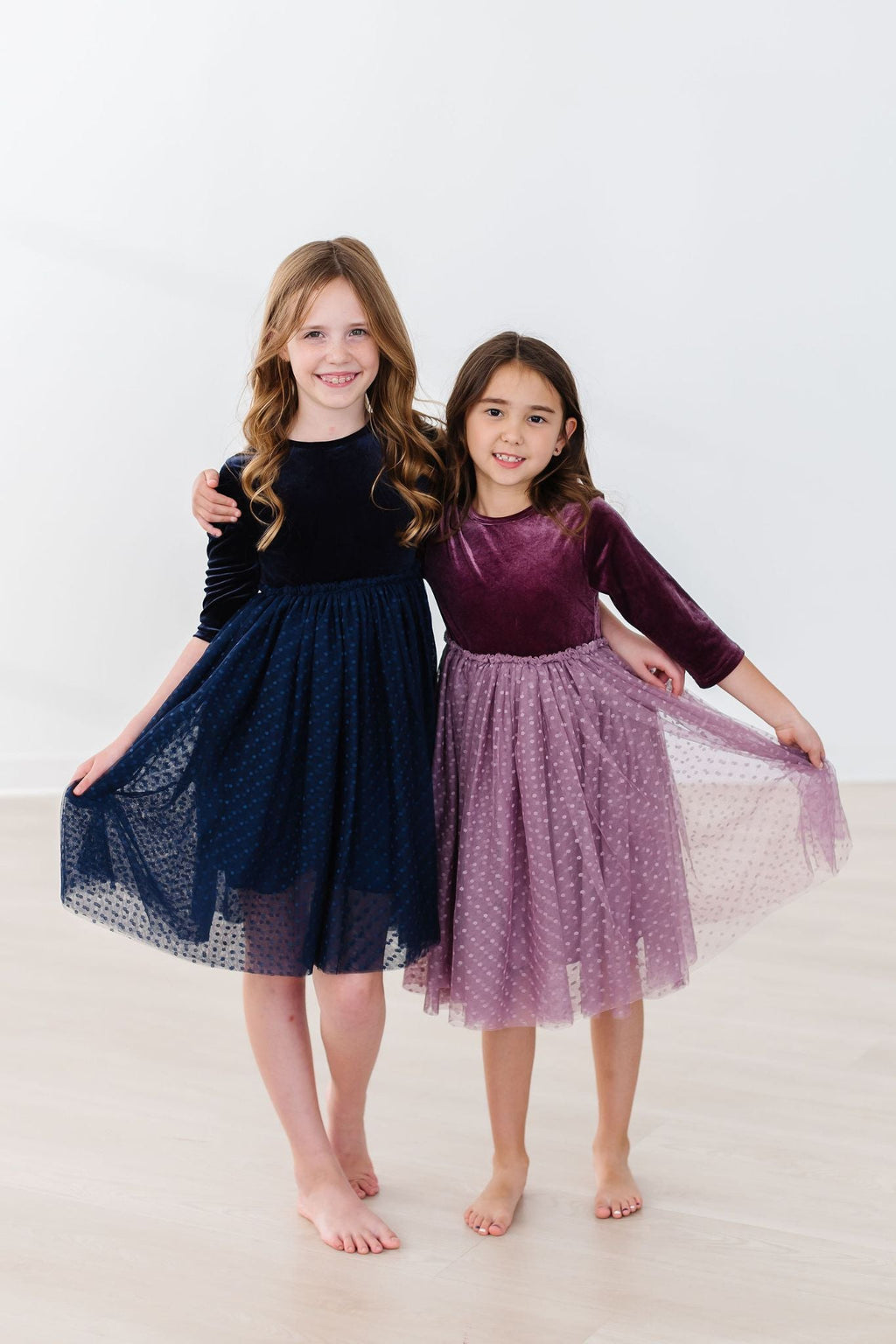 Navy velvet tutu dress on girl, long sleeves and flared dotted tulle skirt