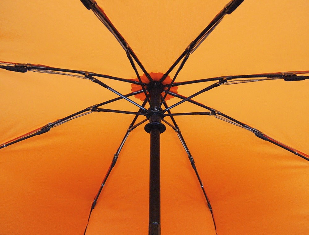 Orange umbrella top view showing frame ribs and central hub.