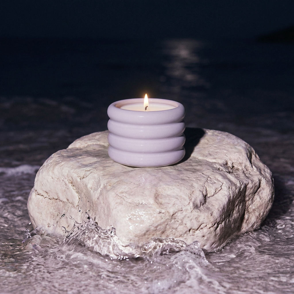 Lilac ridged ceramic soy wax candle jar with lit wick