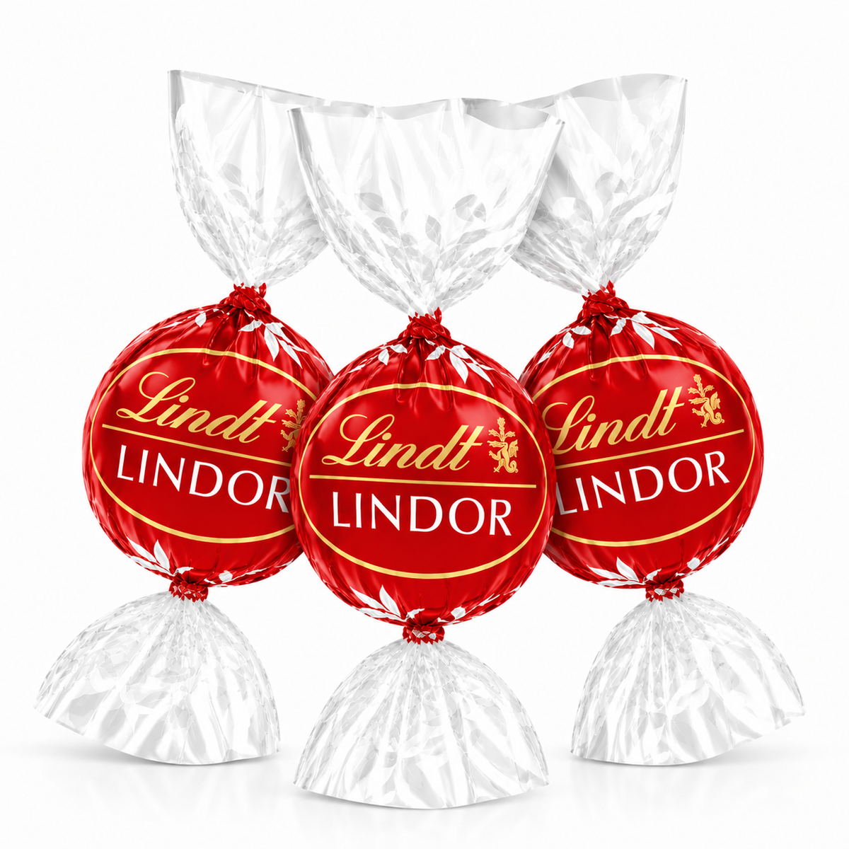 Milk chocolate truffles in red Lindt LINDOR foil, with white paper wrap pieces.